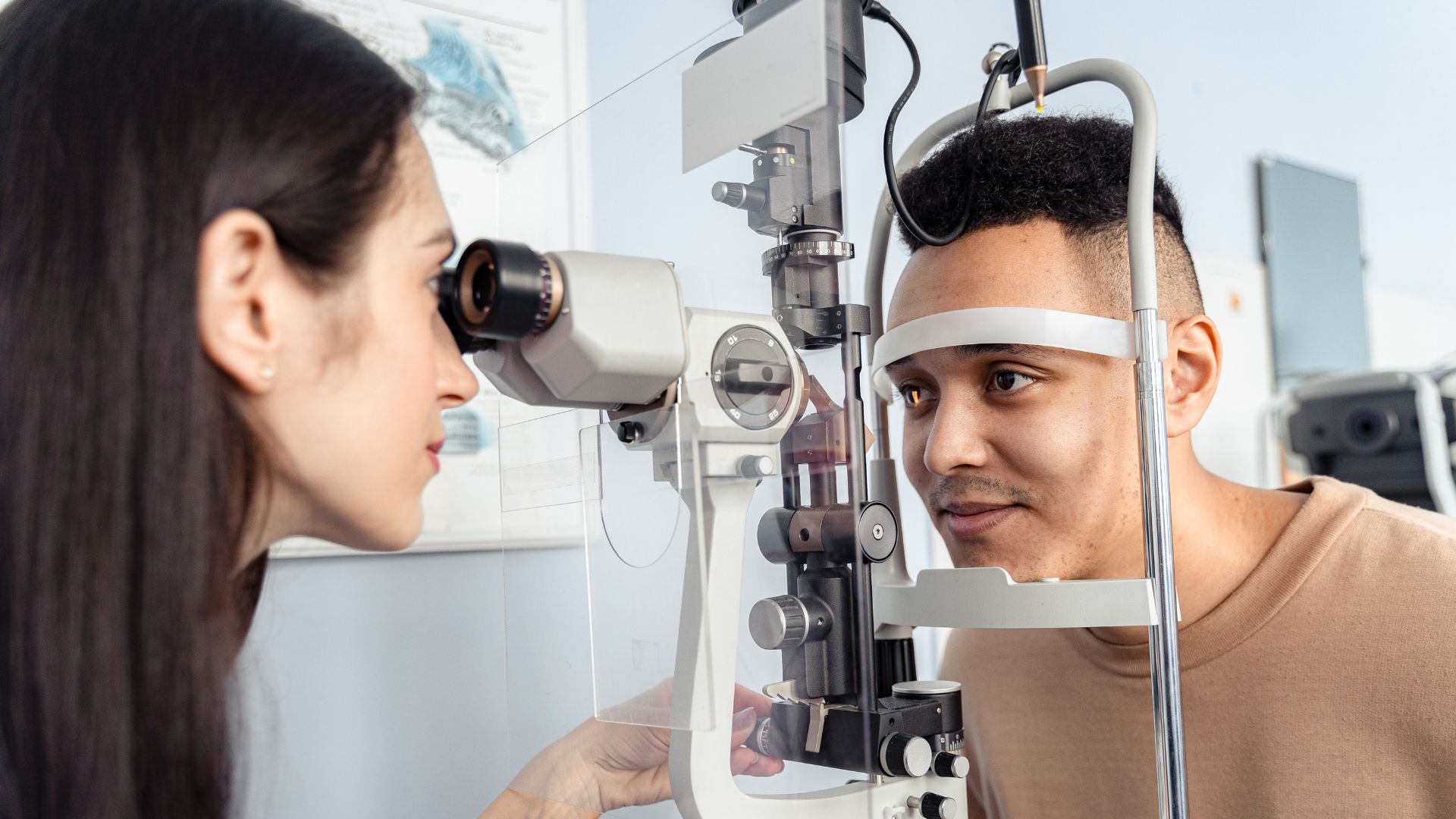 A well-lit consultation room, a professional optometrist in a white coat sitting at a desk, intently examining a pair of blue light glasses, with various eye health diagrams and charts displayed on the walls behind them. The scene exudes an atmosphere of expertise and attentive care, inviting the viewer to imagine themselves seeking advice on the benefits of blue light glasses and how they can protect their eyes from the strain of digital screens. Blue Light Glasses 01