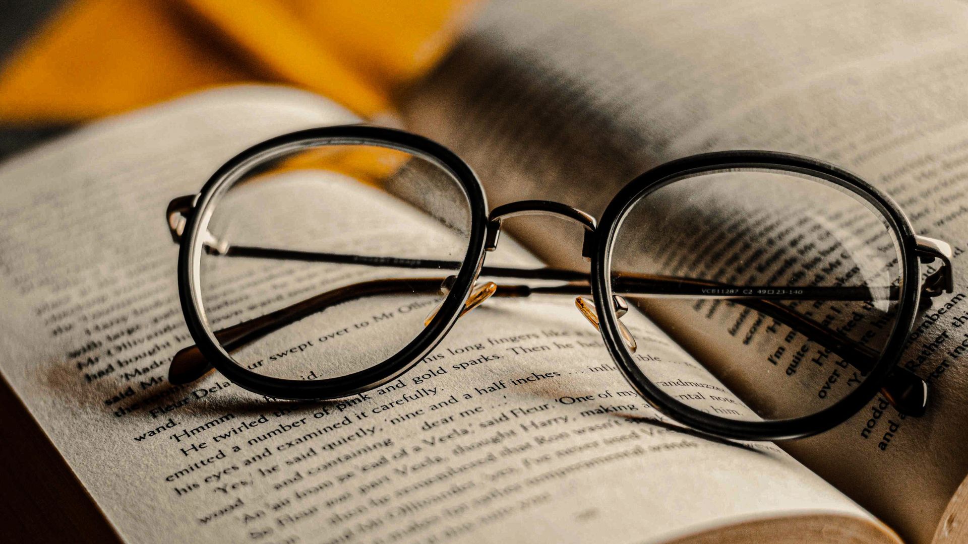 A still life arrangement showcasing the benefits and drawbacks of eyeglasses. In the foreground, a pair of sleek, modern eyeglasses rests on a wooden surface, reflecting the light from a warm, directional lamp. In the middle ground, an open book and a cup of coffee represent the improved focus and clarity that eyeglasses can provide. In the background, a blurred city skyline through a window suggests the optical distortion and limited field of view that eyeglasses can sometimes introduce. The overall mood is one of thoughtful contemplation, balancing the pros and cons of this ubiquitous vision correction tool. Eyeglasses vs. Contact Lenses 02
