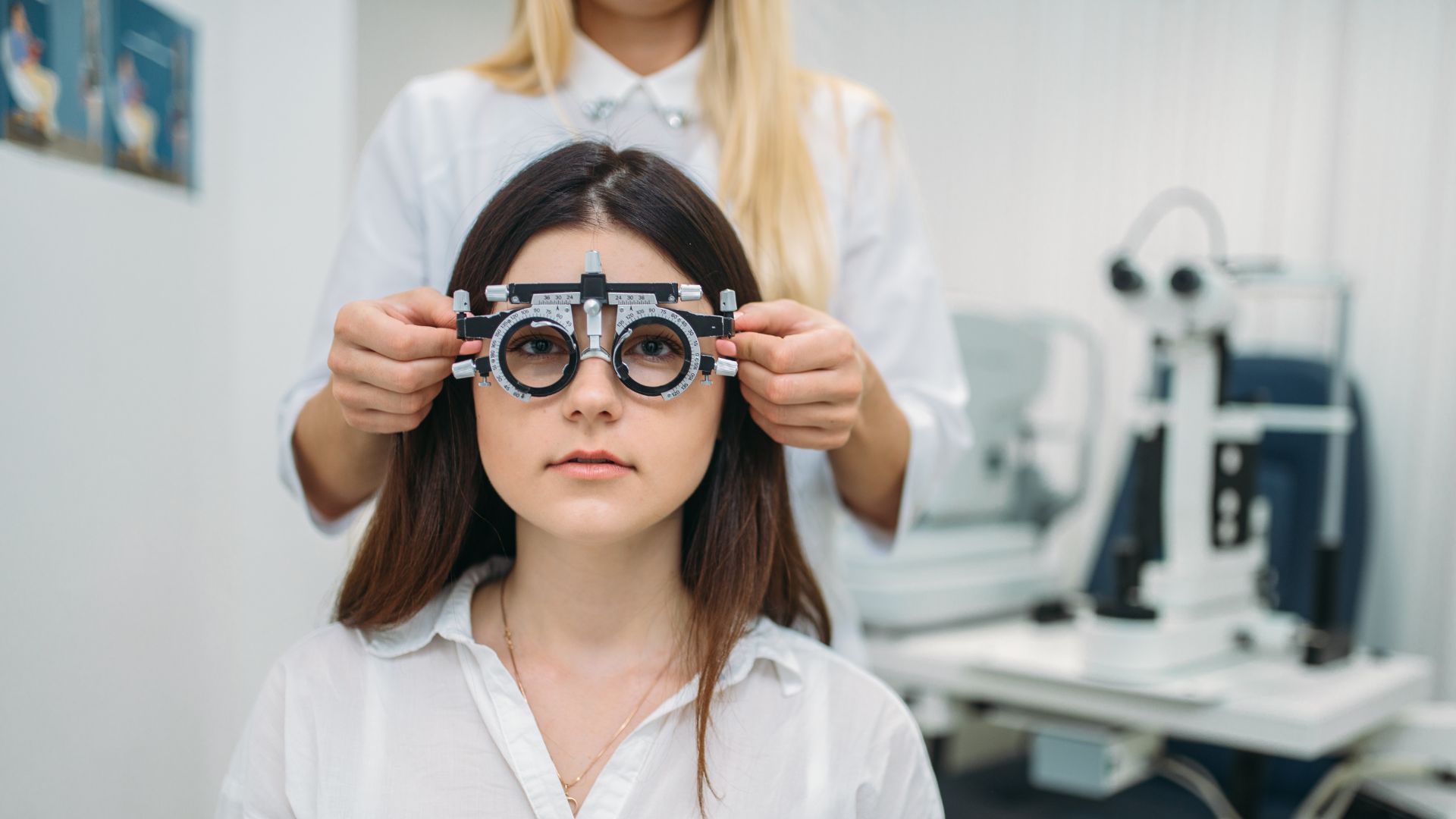 A dimly lit doctor's office, the patient seated nervously as the ophthalmologist examines their eyes with a slit lamp. The clinical setting is accentuated by the crisp, cool lighting, drawing attention to the intricate structure of the eye. In the background, a wall-mounted chart displays various eye conditions, hinting at the potential causes of the patient's poor night vision. The doctor's focused gaze and the patient's slightly worried expression convey the seriousness of the evaluation, underscoring the importance of seeking professional help for such a delicate issue. Night Vision Problems 06
